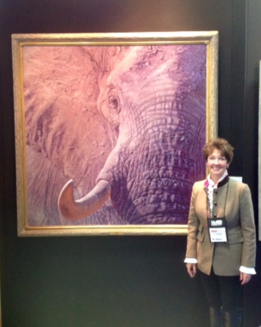 Rita Schimpff of Heritage Game Mounts next to 'Tusk' by John Banovich at convention
