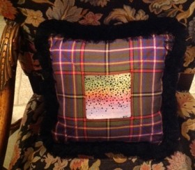 Hand painted rainbow trout skin sewn into a tartan pillow.