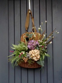 Vintage fishing creel filled with spring flowers for door decor