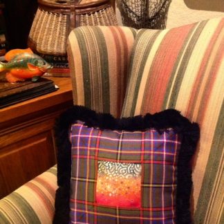 Brook trout spots painted on lambskin and framed in tartan & fringe