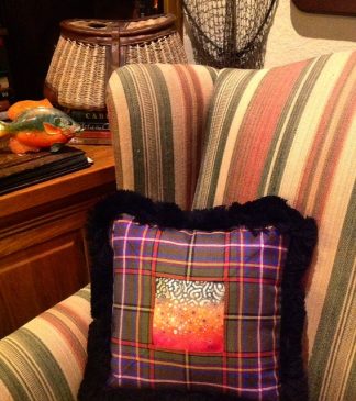 Brook trout spots painted on lambskin and framed in tartan & fringe